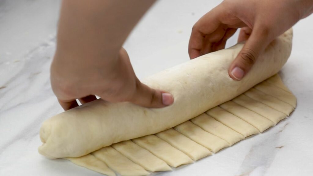 shaping the dough into a loaf of bread