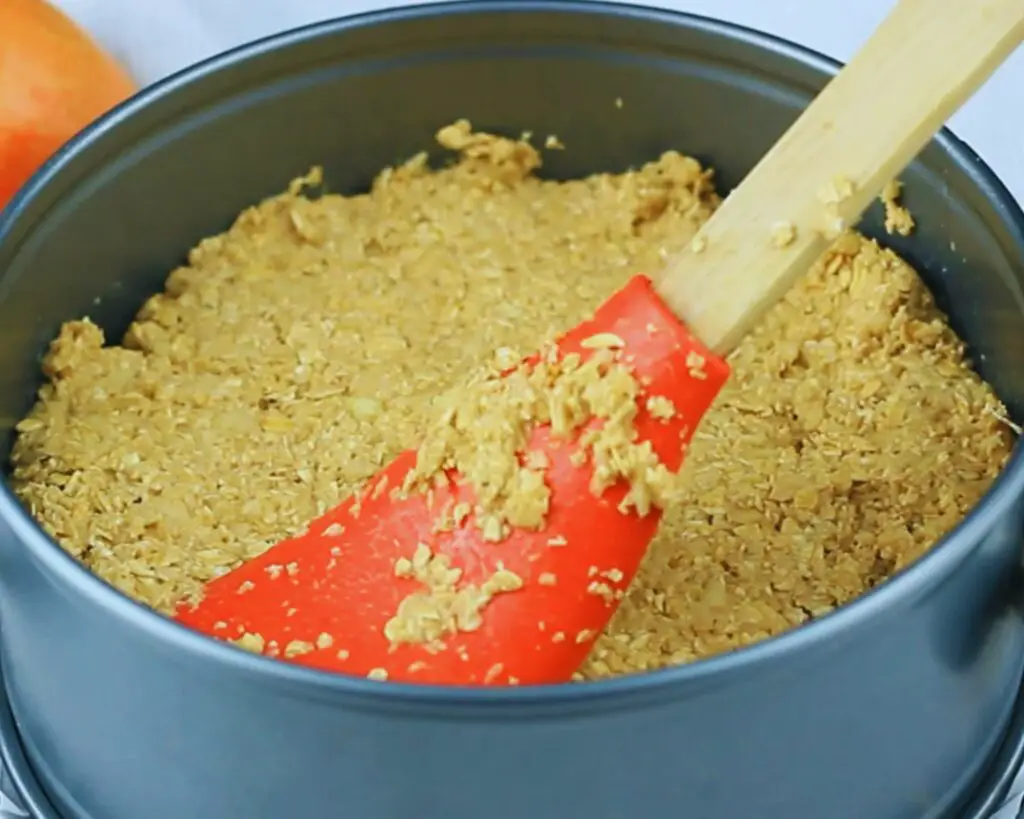 smooth out the top of the oat cake before baking it