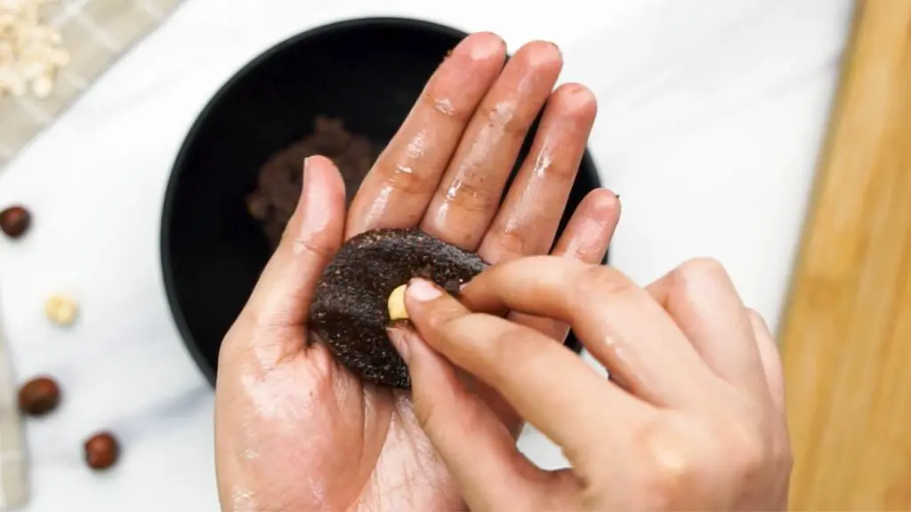 folding one hazelnut inside the dough