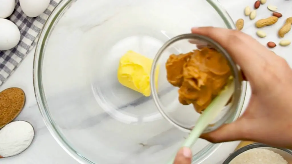 mixing butter and peanut butter in the mixing bowl