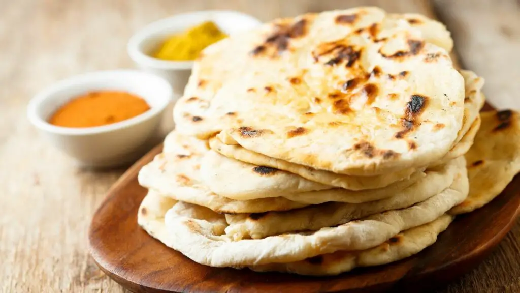 Naan bread on a wooden plate