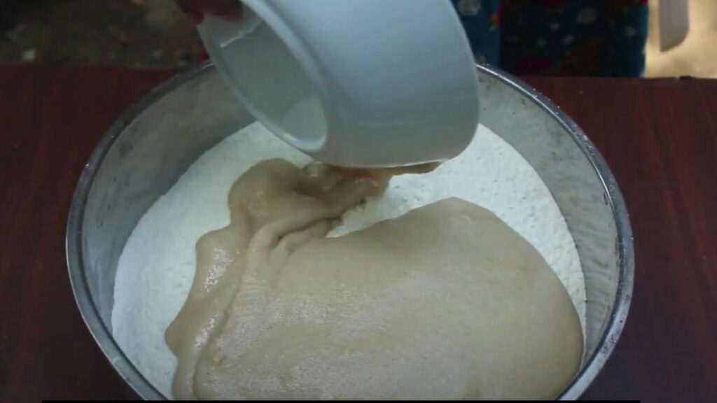 adding the activated yeast mixture to the flour