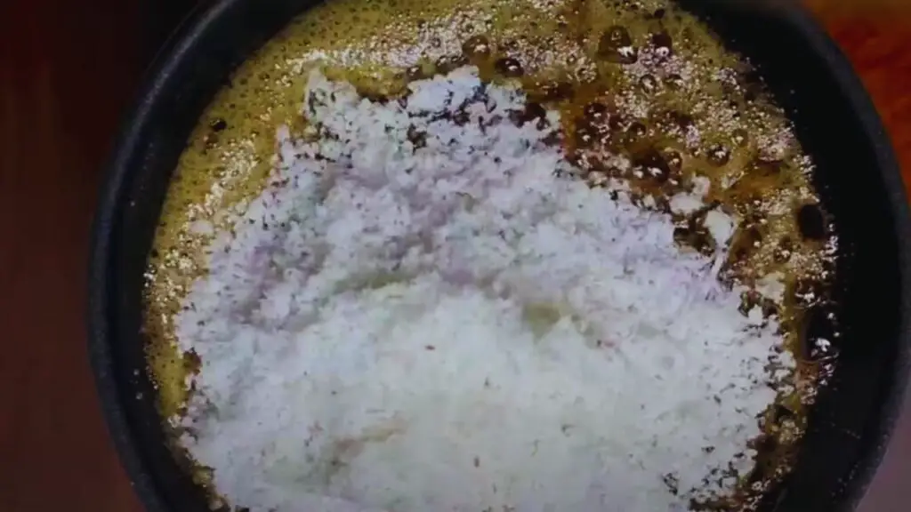 cooking the coconut in a pan