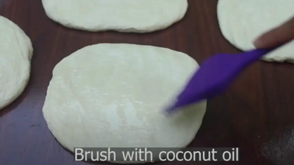 covering the surface of the flatbreads with coconut oil