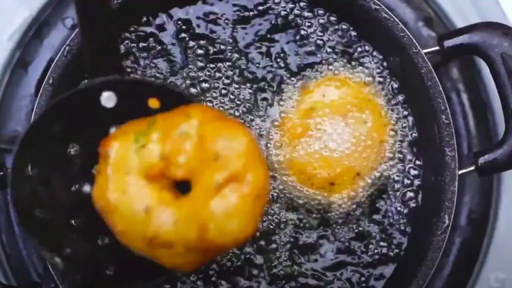 frying the donuts in a pan