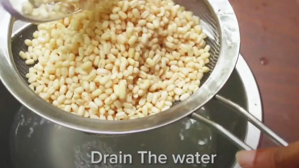 using a strainer to drain out the water