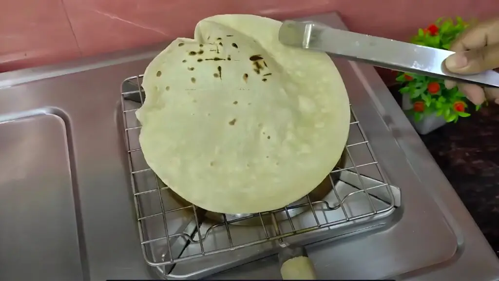 cooking the roti straight onto the open flame
