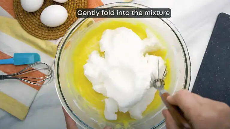 folding the beaten egg whites into the cake batter