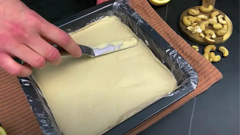 spreading the filling across the crust using a spatula