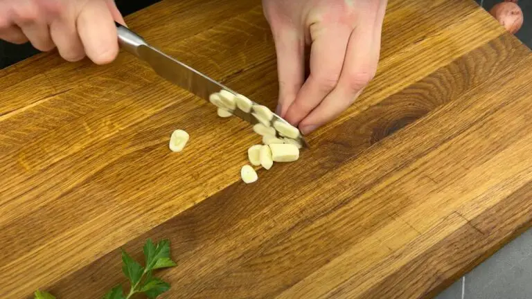 slicing of garlic in preparation of vegetable