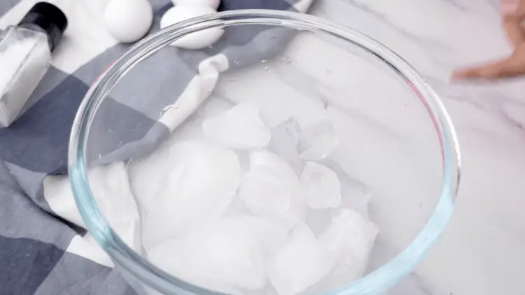 putting ice and salt on a bowl