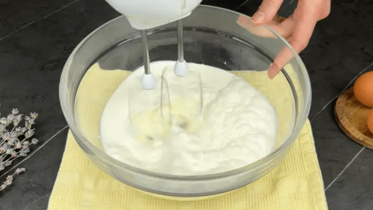 beating the cream with a hand mixer