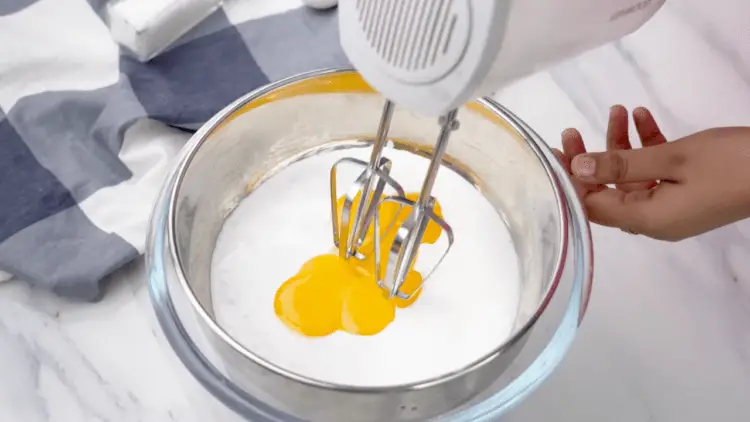 whisking the mixture with a hand mixer