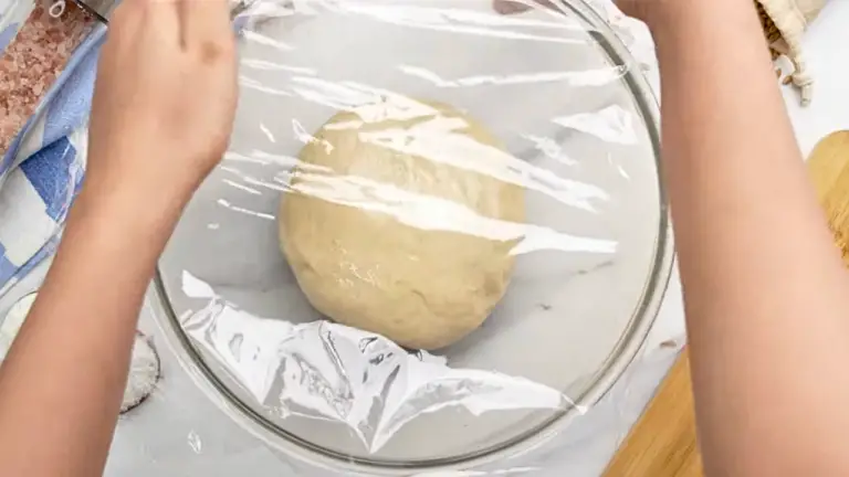 covering the dough in a bowl to let the dough rise