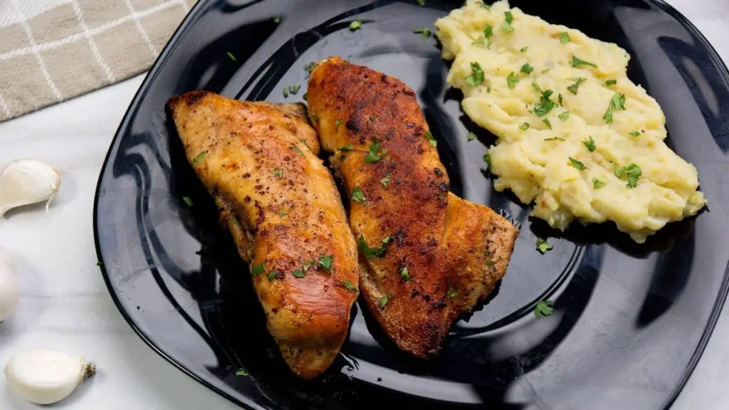 chicken breast in a pan with butter