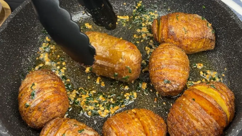 Roll potatoes in garlic butter