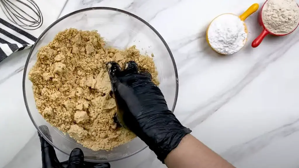 mixing butter into the flour until it looks like coarse crumbs