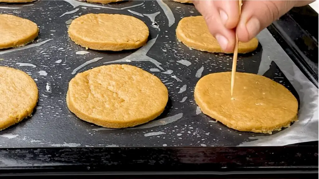 poking small holes in each biscuit