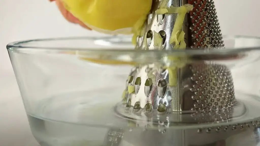 shredding of potatoes in a bowl of cold water