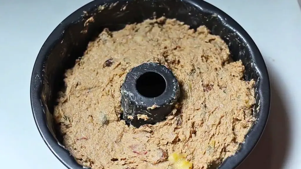 adding the batter into the cake pan