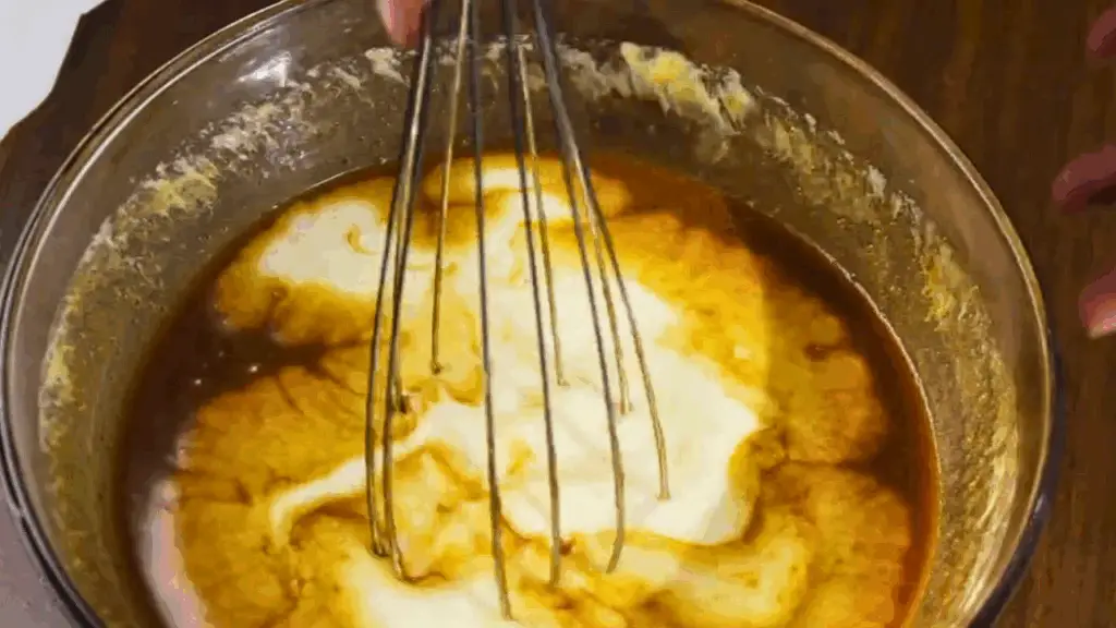 pouring of coconut milk for an extra moist banana coconut bread