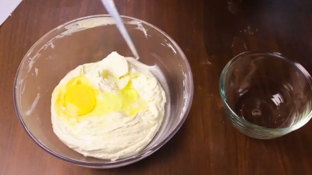 adding eggs to the semolina cake batter