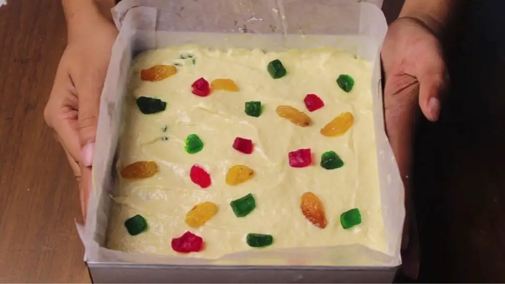 preparing the pan and adding candied fruits on top