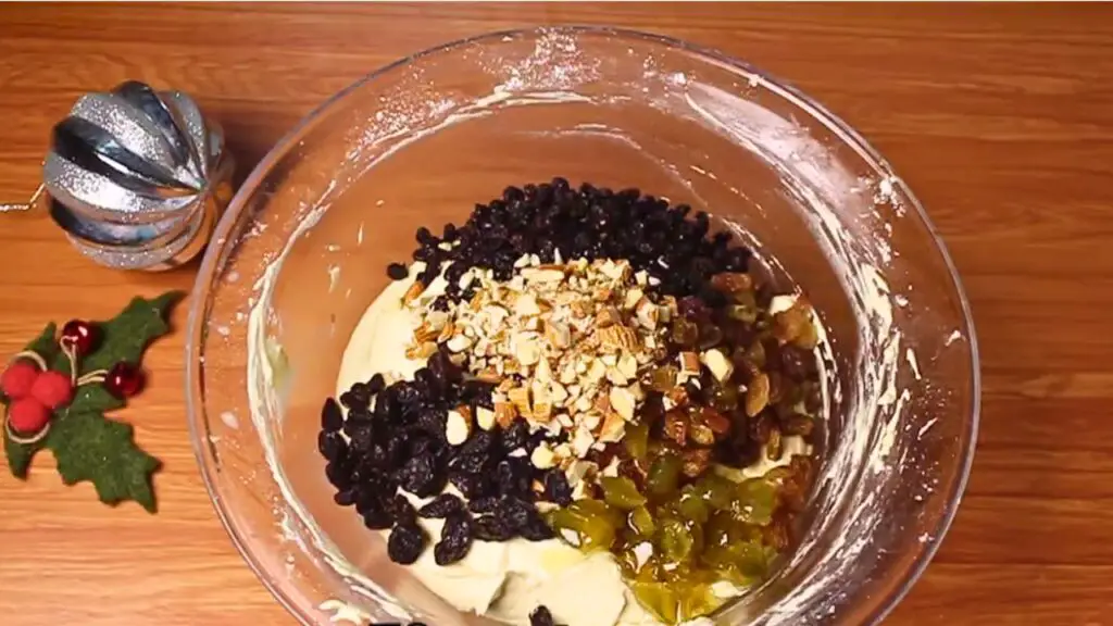 adding the dried fruits and nuts to quick fruit cake batter