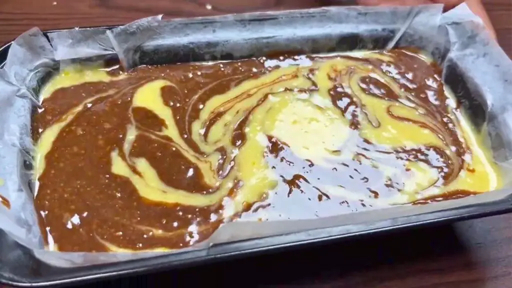 creating swirl into vanilla chocolate swirl cake