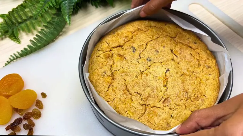 Simple oatmeal apple and carrot cake in a parchment-lined pan.