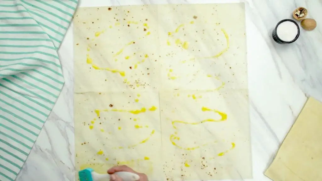 layers of thin, golden baklava phyllo sheets brushed with butter