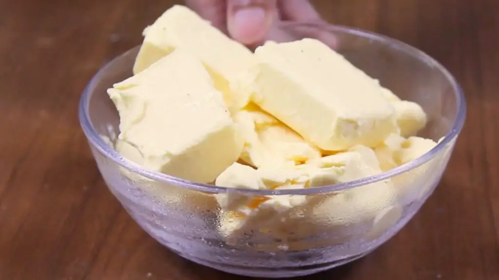 Cubed unsalted butter in a glass bowl being melted for lemon brownies