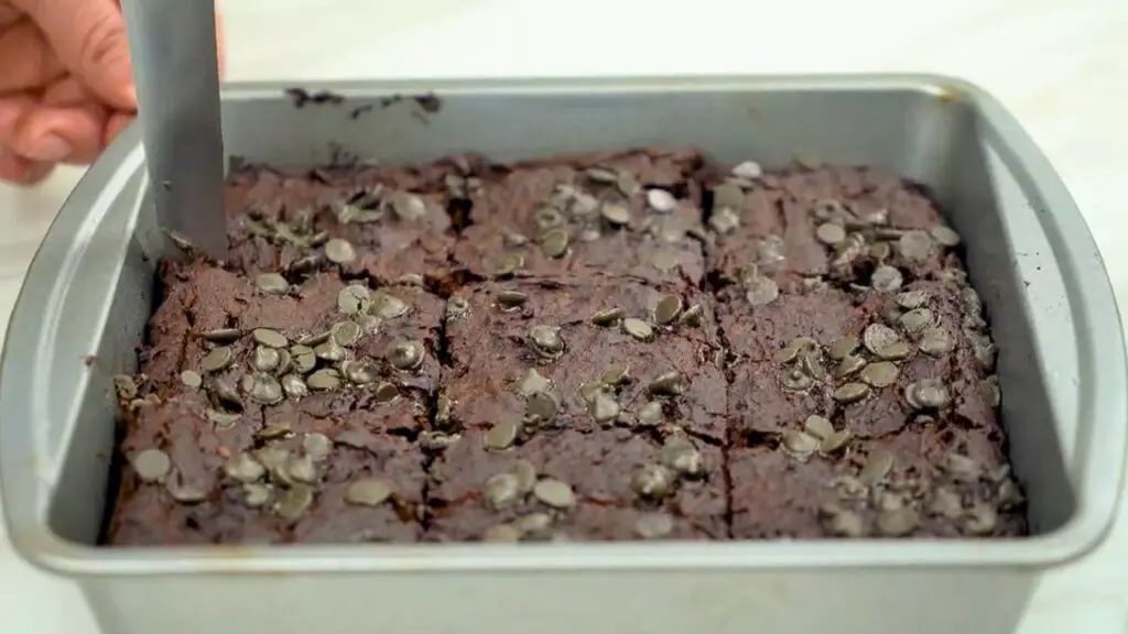 slicing of fudgy black bean brownies