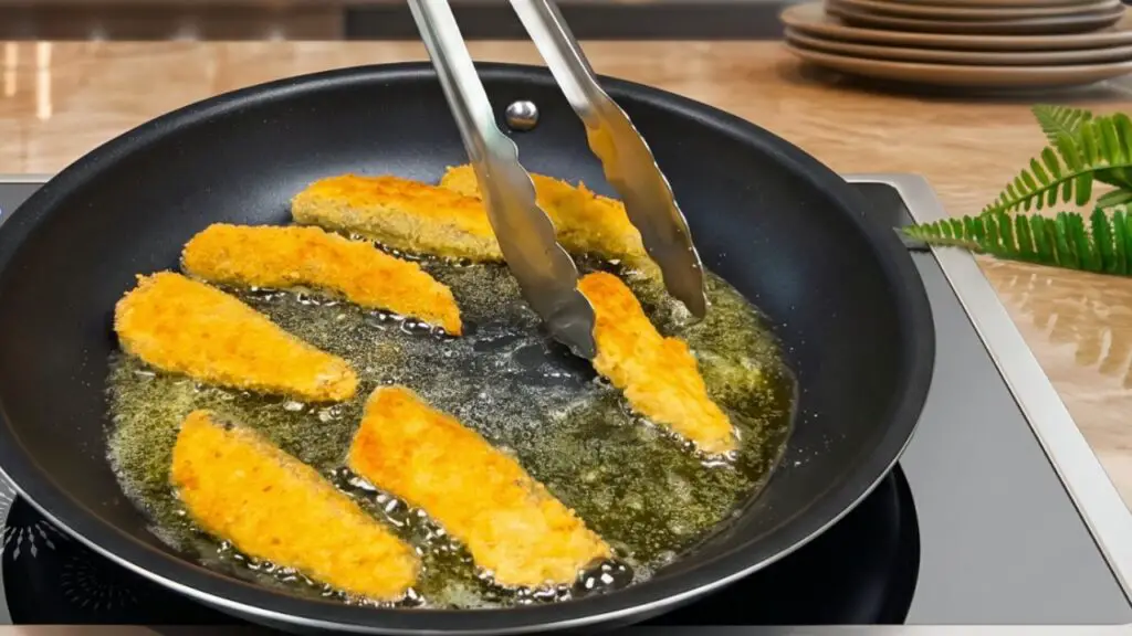 Carefully place the coated sardines into the hot oil