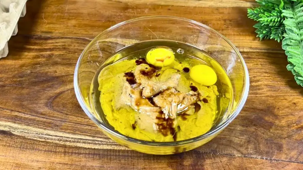 Date mixture, eggs, olive oil, and vanilla extract combined in a bowl to make a simple moist date cake recipe with oil.