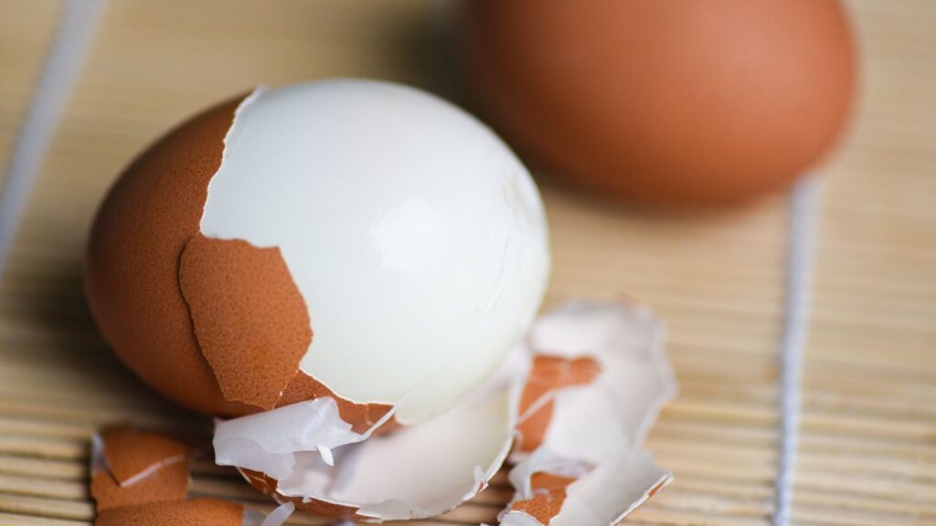 Air fryer boiled eggs cooling in ice water to help stop the cooking process and make peeling easier.