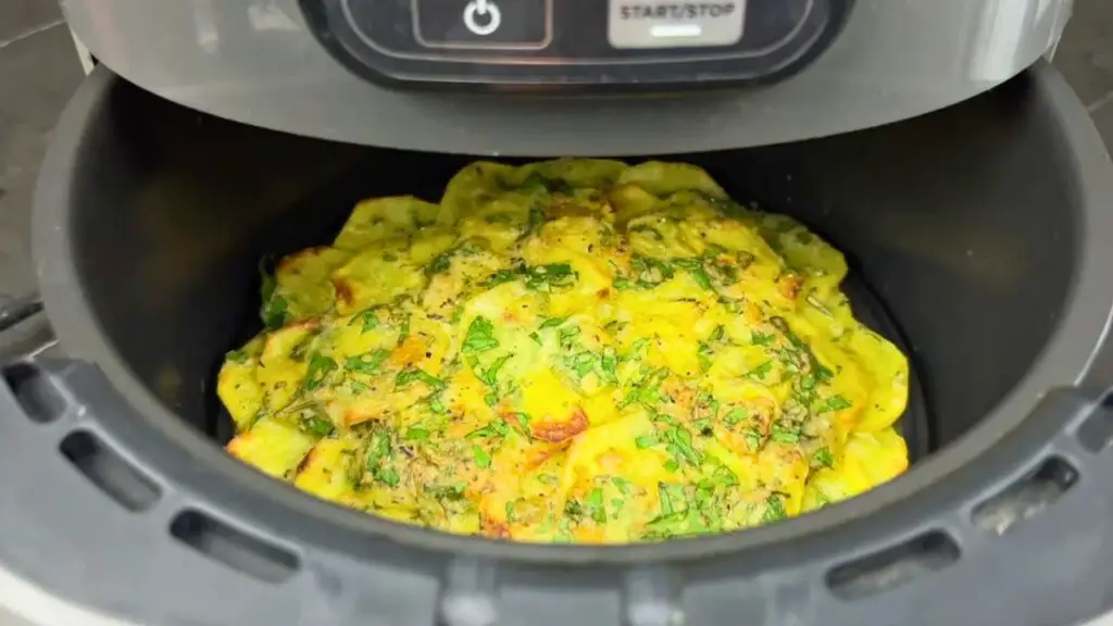 Cheesy air fryer potatoes cooked until golden and crispy.