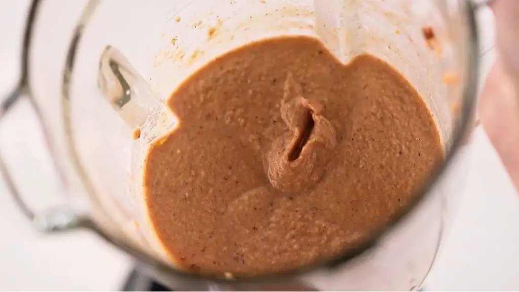 Thick protein waffles recipe batter blended smooth in a blender jar, ready to pour into a waffle maker.