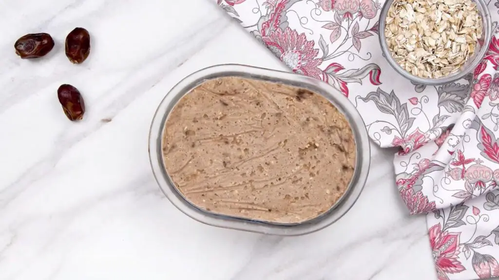 Homemade oat ice cream mixture smoothed in a freezer-safe dish before chilling in the freezer.