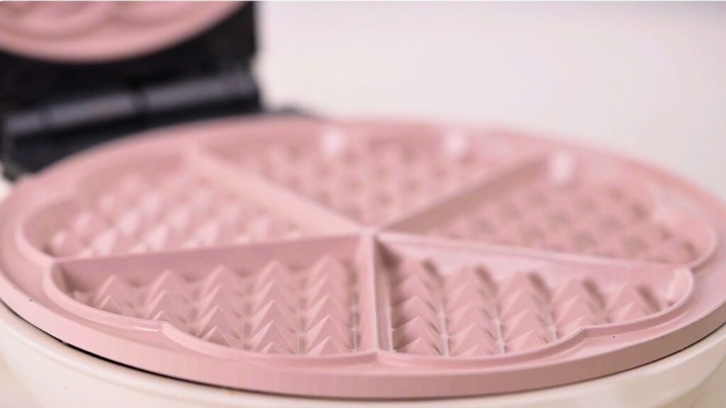How to make waffles with a waffle iron using a clean nonstick waffle maker, showing the waffle plates ready for batter without greasing before cooking homemade waffles.