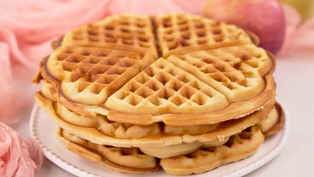 Waffle maker recipe showing a stack of homemade apple waffles with a golden, lightly crisp exterior, ready to reheat in a toaster, oven, or air fryer while staying soft and fluffy inside.