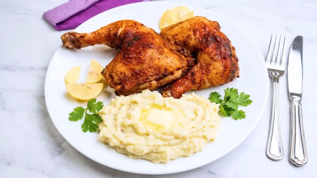 make me an image where these chicken legs are served with mashed potatoes