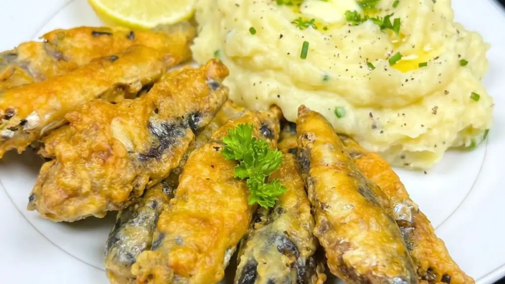 fried sardines served with mashed potatoes