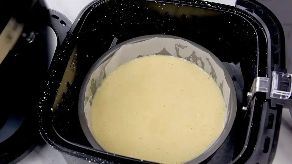 Best yogurt cake recipe showing the cake batter in a parchment-lined pan, ready to bake in the air fryer.