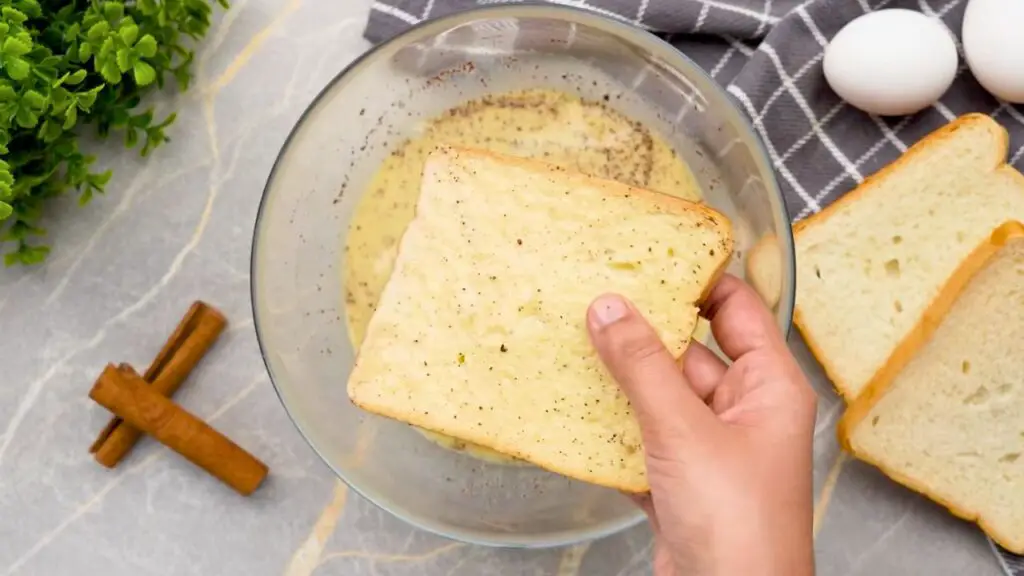 Bread dipped in the egg mixture for crispy air fryer French toast.