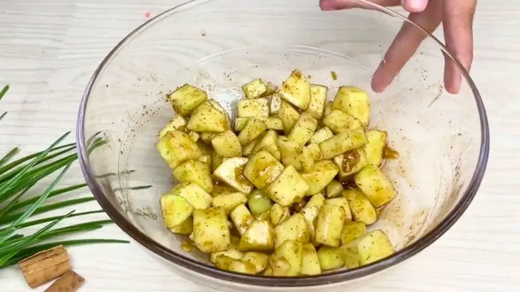 Chopped apples tossed with brown sugar and cinnamon for a moist apple cinnamon loaf cake, then left to rest and release their juices.