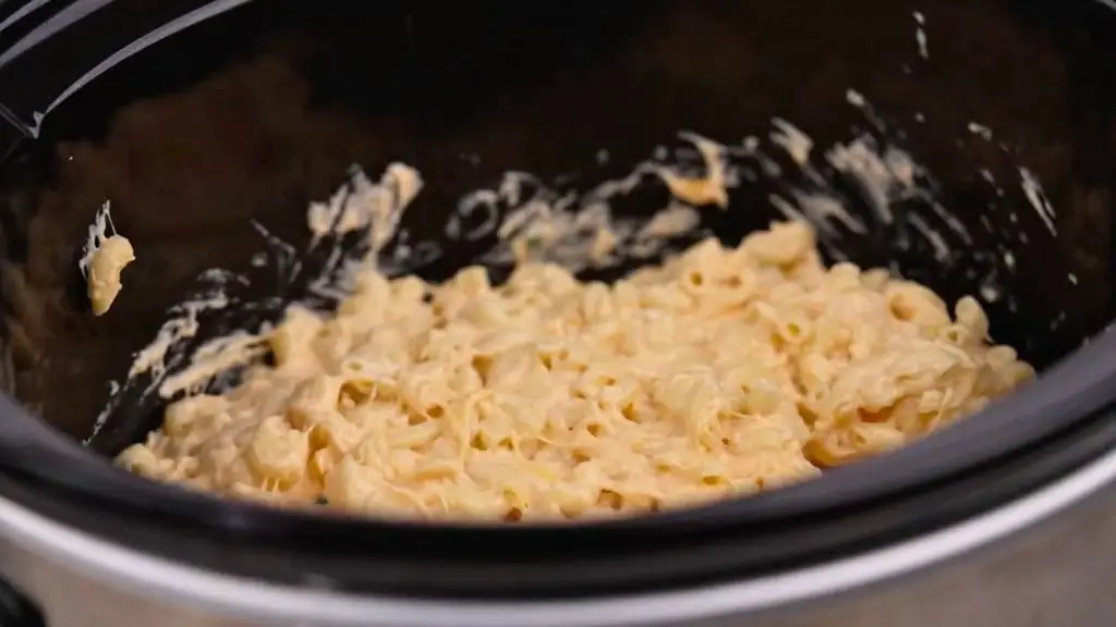 Creamy crockpot macaroni and cheese after slow cooking, with melted cheese coating the tender macaroni.