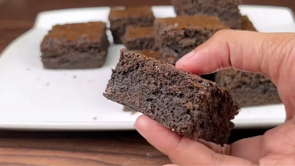 Fudgy brownies from scratch showing the rich, moist center before reheating.