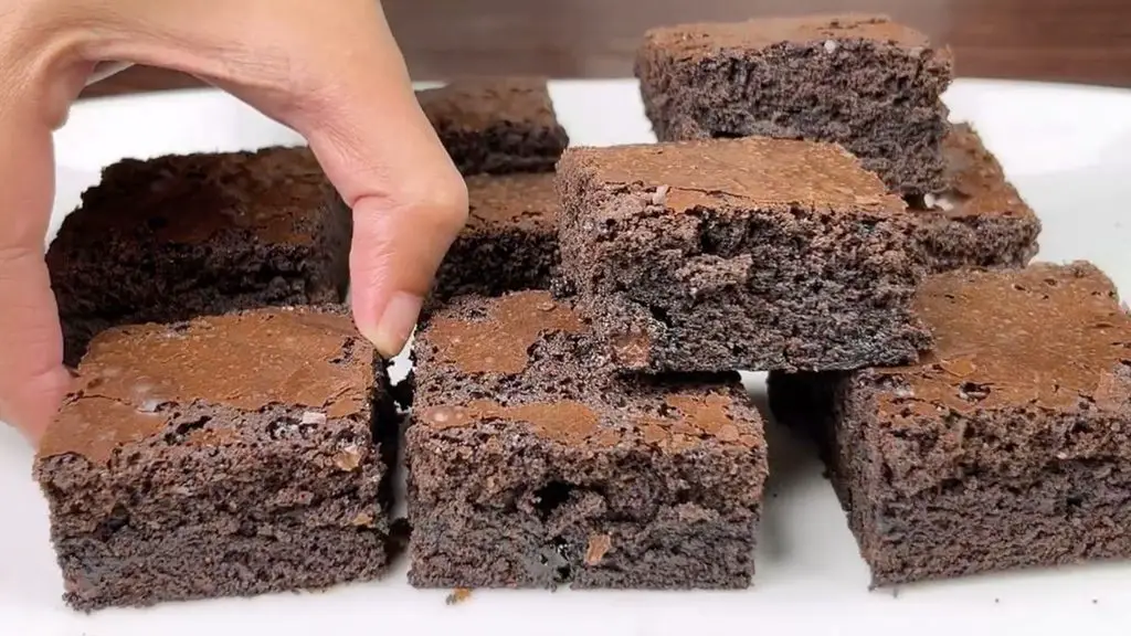 Fudgy brownies recipe showing thick chocolate brownie squares with rich, moist centers and crackly tops.
