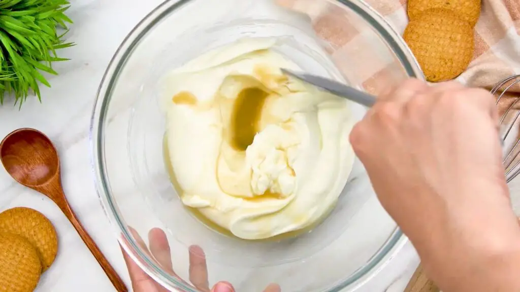 Mixing vanilla extract and lemon juice into the filling for the ultimate no bake cheesecake.